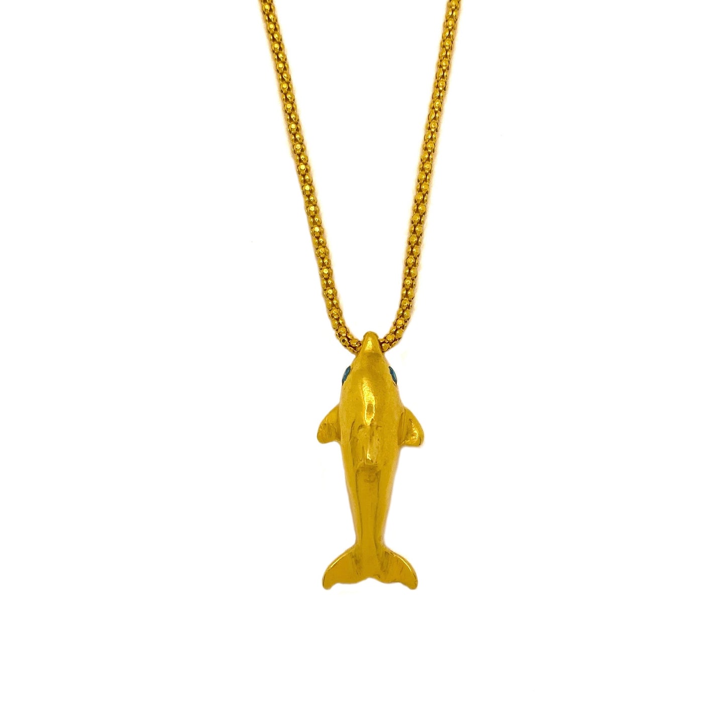 Gold dolphin pendant with blue sapphire