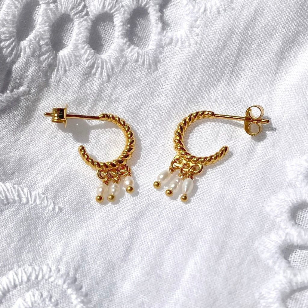 Twisted gold hoop earrings with pearls