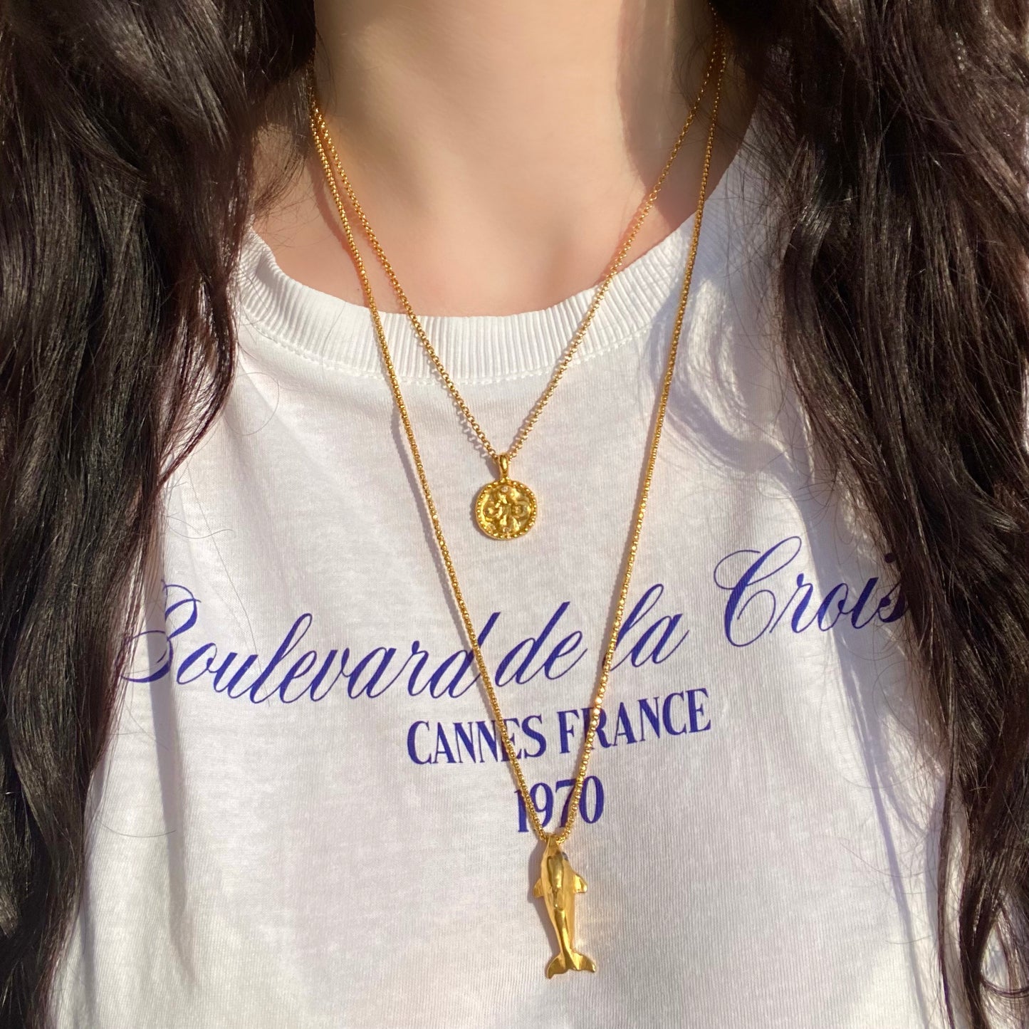 Gold dolphin necklace with blue sapphires